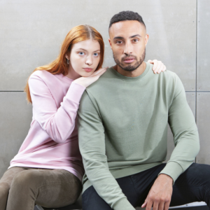 A woman and man wearing the M194 Sweatshirt