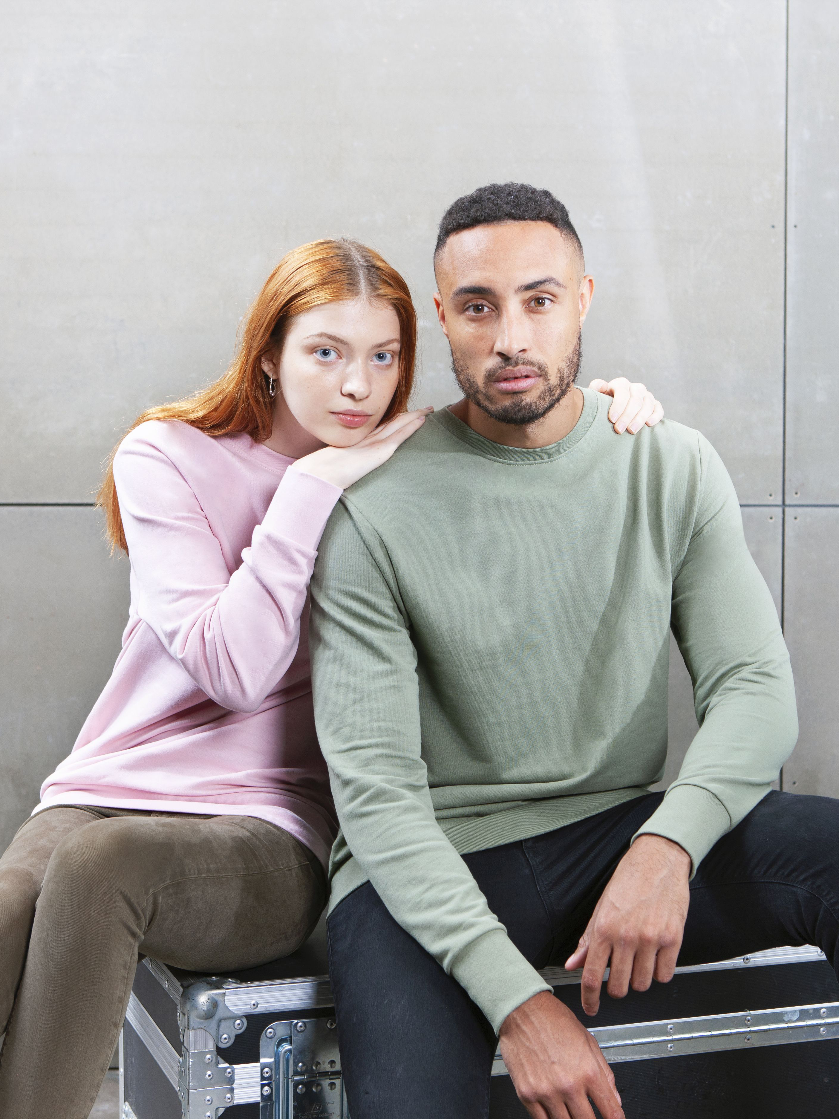 A woman and man wearing the M194 Sweatshirt